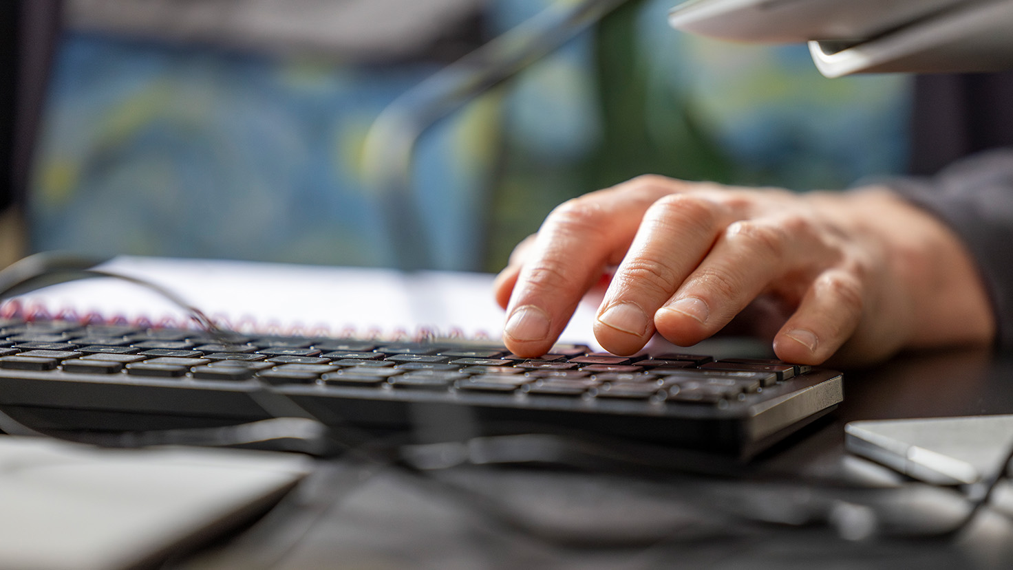 Close up of hands on a keyboard
