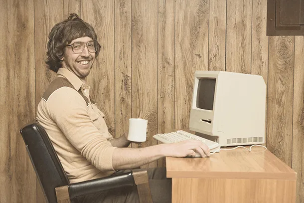 A man working at an old computer