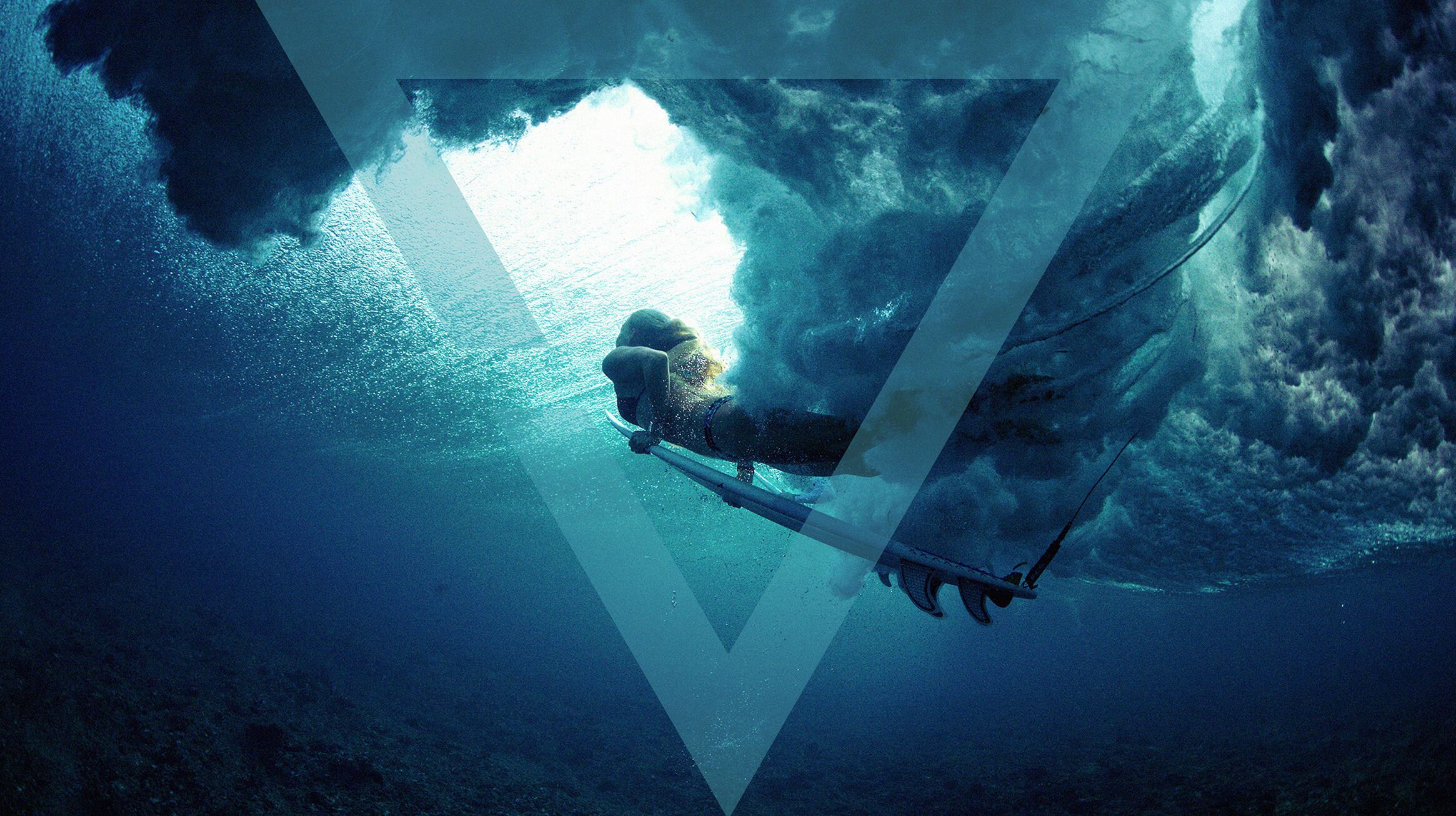 Woman surfing under a wave