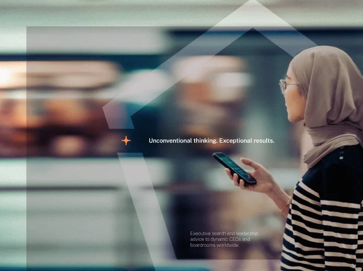 A woman standing on a train platform looking at a phone