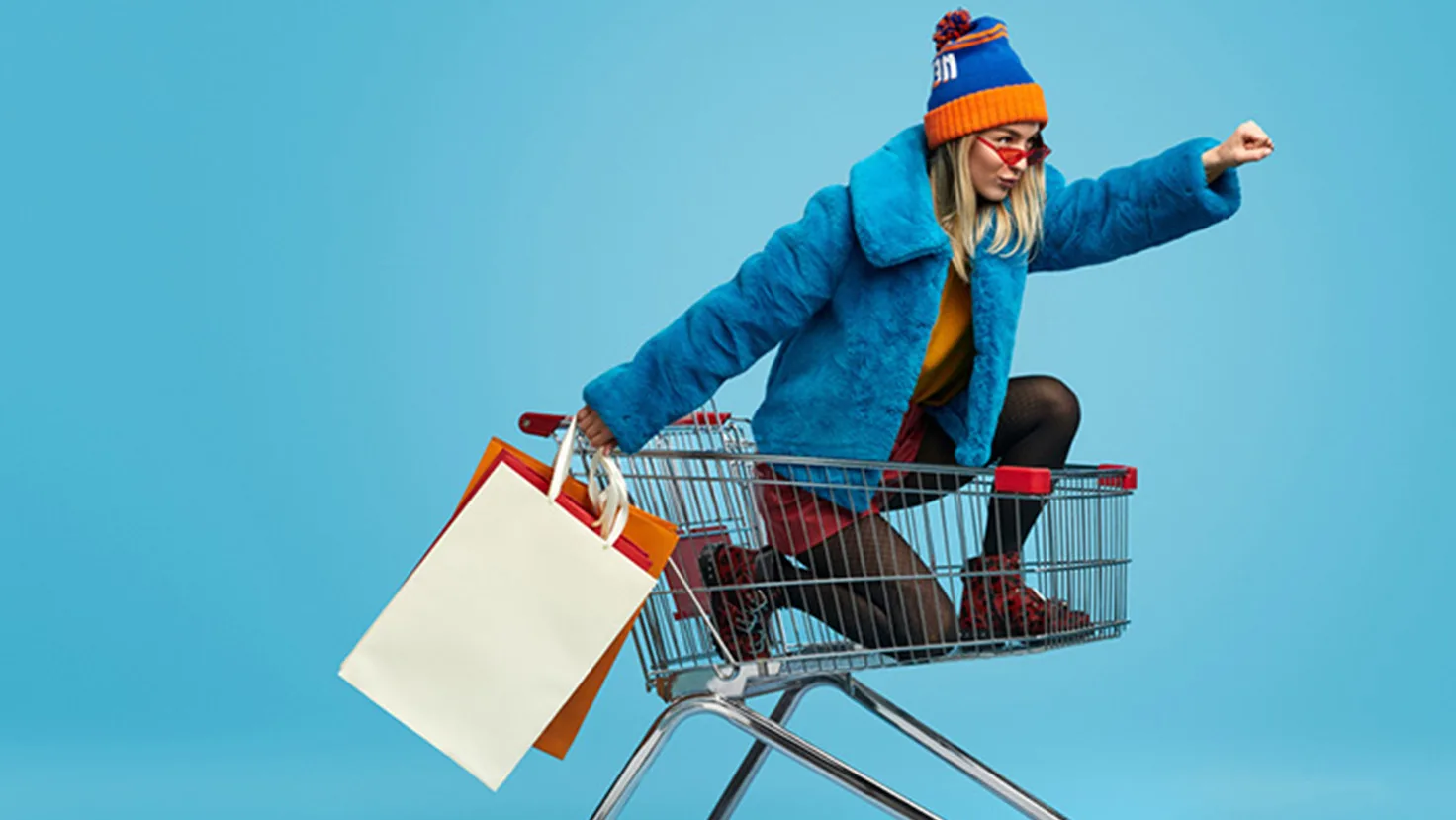 Lady in shopping trolley with shopping bags