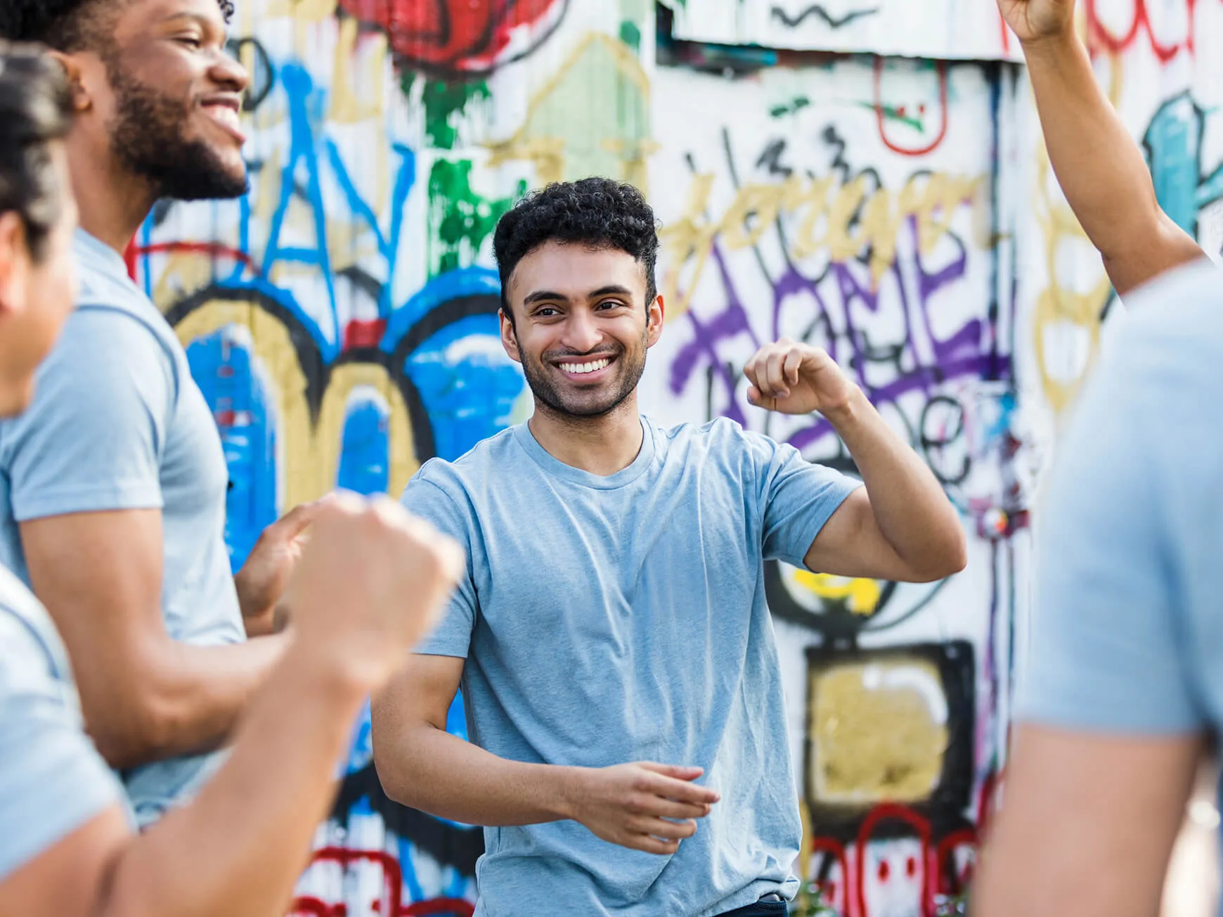 A young male charity worker smiling.