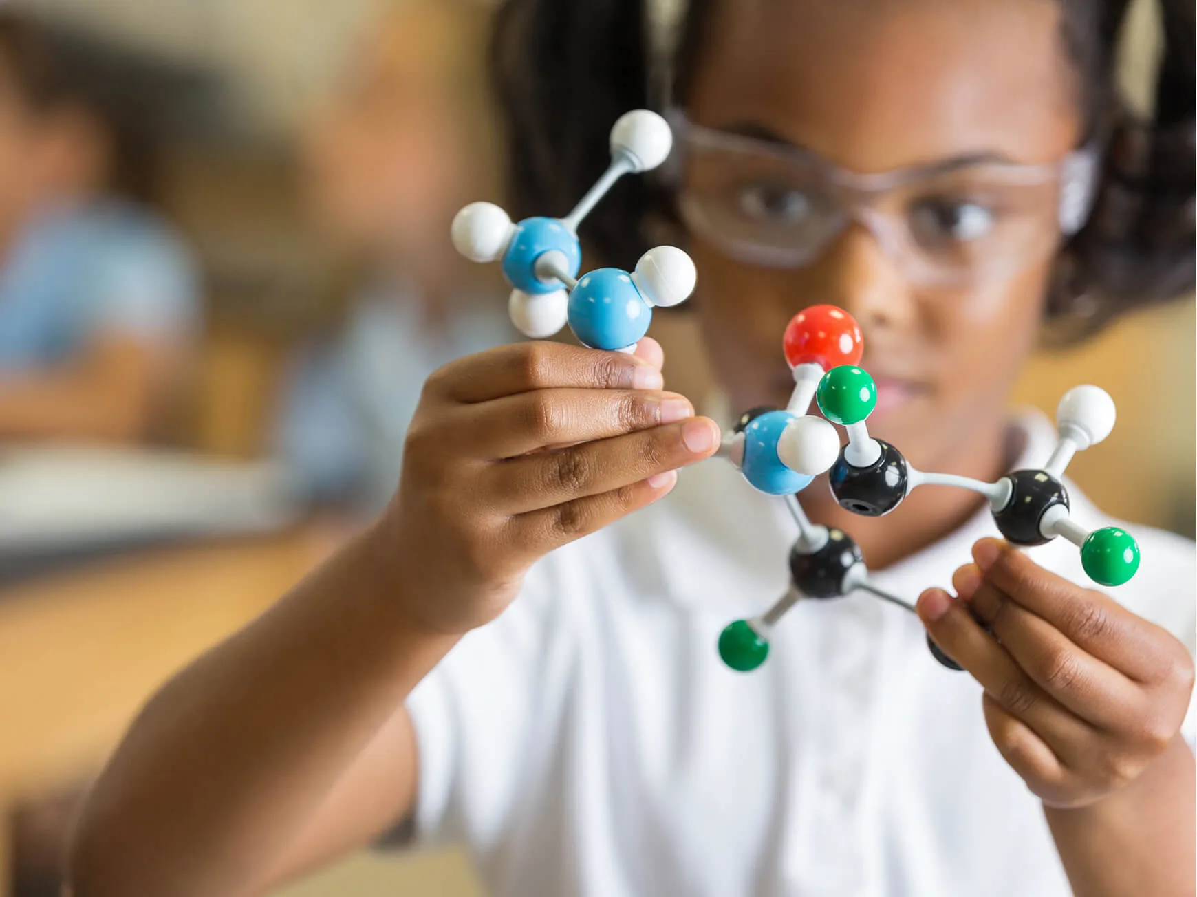 A young female student looking at molecular ball-and-stick model